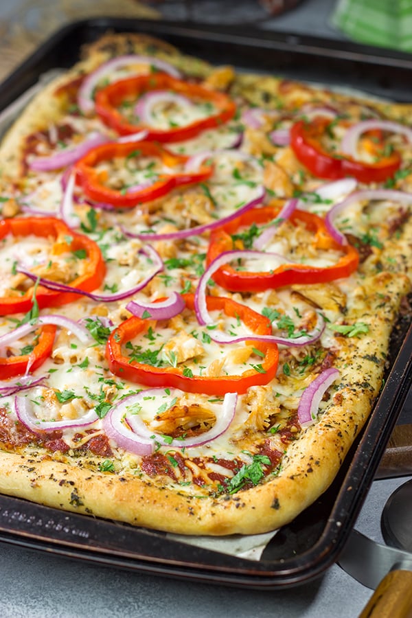 Mix up pizza night with this Tuscan Chicken Pizza! Topped with chicken, red bell peppers and a generous amount of Italian herbs, this pizza makes for a tasty (and easy) meal!