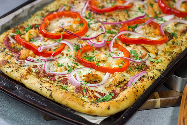 Mix up pizza night with this Tuscan Chicken Pizza! Topped with chicken, red bell peppers and a generous amount of Italian herbs, this pizza makes for a tasty (and easy) meal!