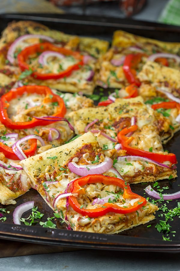 Mix up pizza night with this Tuscan Chicken Pizza! Topped with chicken, red bell peppers and a generous amount of Italian herbs, this pizza makes for a tasty (and easy) meal!