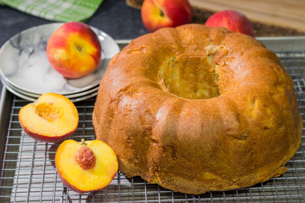 This Fresh Peach Pound Cake is packed with the flavor of summer! Grab a slice and enjoy it on the back porch this weekend!