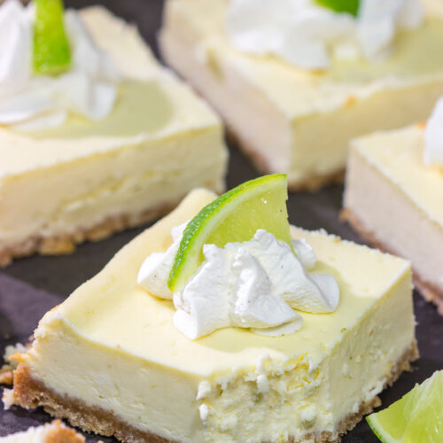 Featuring a hint of tequila + lime flavor in a creamy cheesecake filling, these Margarita Cheesecake Bars are a fun and tasty summer dessert recipe!