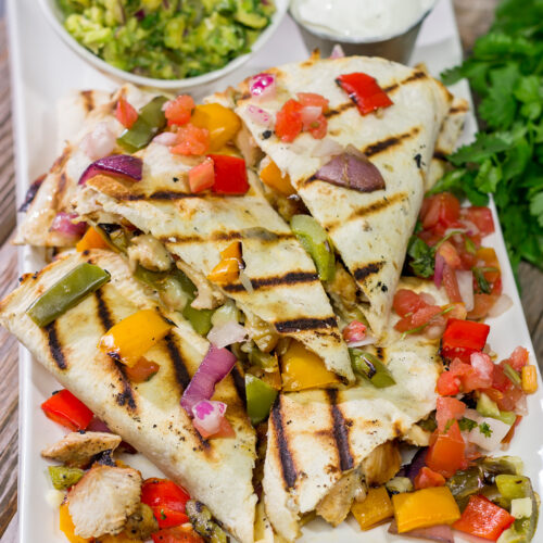 These Pineapple Margarita Chicken Quesadillas are filled with grilled chicken, pineapples, onions and peppers - and the chicken gets marinated in margarita mix for a fun twist!