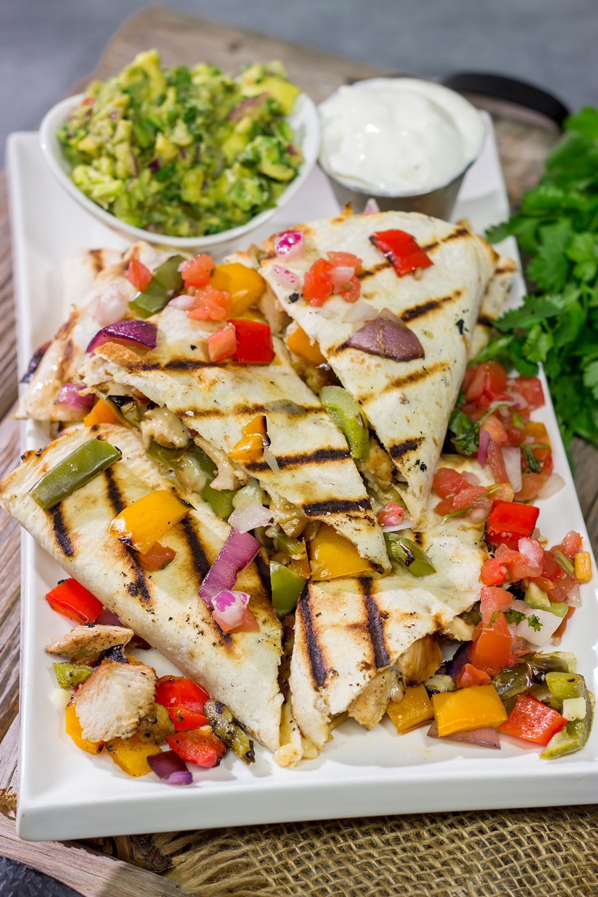 These Pineapple Margarita Chicken Quesadillas are filled with grilled chicken, pineapples, onions and peppers - and the chicken gets marinated in margarita mix for a fun twist!