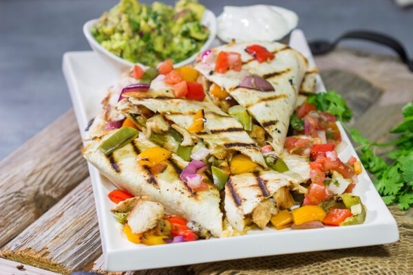 These Pineapple Margarita Chicken Quesadillas are filled with grilled chicken, pineapples, onions and peppers - and the chicken gets marinated in margarita mix for a fun twist!
