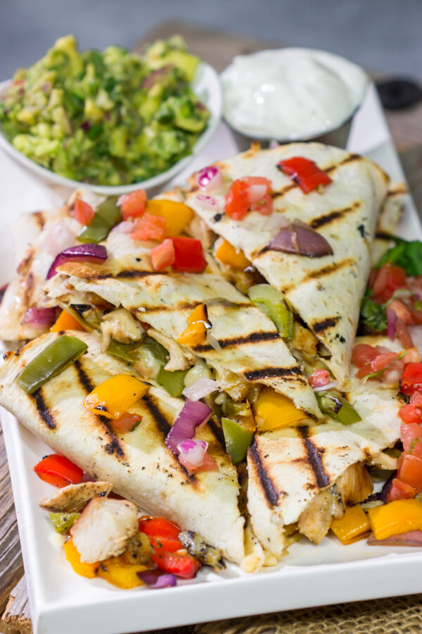These Pineapple Margarita Chicken Quesadillas are filled with grilled chicken, pineapples, onions and peppers - and the chicken gets marinated in margarita mix for a fun twist!