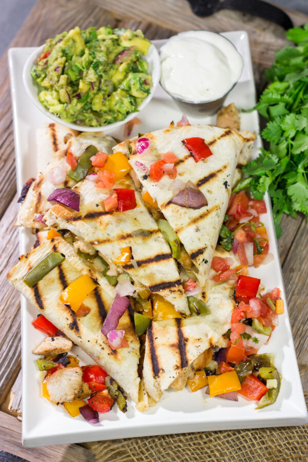 These Pineapple Margarita Chicken Quesadillas are filled with grilled chicken, pineapples, onions and peppers - and the chicken gets marinated in margarita mix for a fun twist!