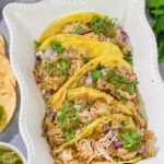 Looking for a good taco recipe? These Slow Cooker Green Chili Tacos are packed with flavor - and they're a real crowd pleaser!