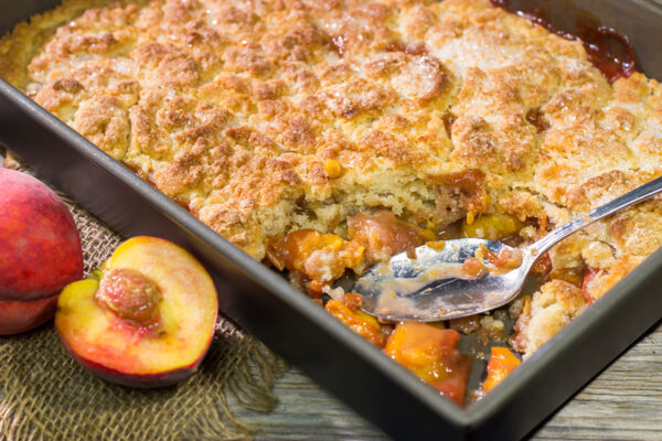 This from-scratch Southern Peach Cobbler recipe features juicy peaches topped with a golden brown, buttery crust. It's the perfect summer dessert!