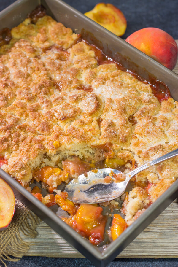 This from-scratch Southern Peach Cobbler recipe features juicy peaches topped with a golden brown, buttery crust. It's the perfect summer dessert!