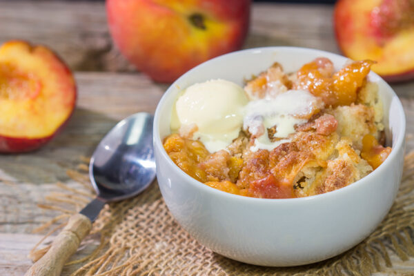 This from-scratch Southern Peach Cobbler recipe features juicy peaches topped with a golden brown, buttery crust. It's the perfect summer dessert!