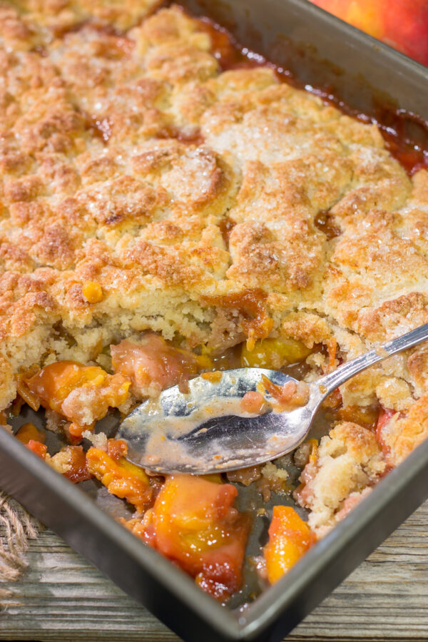 This from-scratch Southern Peach Cobbler recipe features juicy peaches topped with a golden brown, buttery crust. It's the perfect summer dessert!