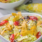 This Southwestern Chopped Salad features grilled corn, shredded cheese and lettuce tossed in a tangy southwestern dressing. Oh, and it gets topped with Fritos!