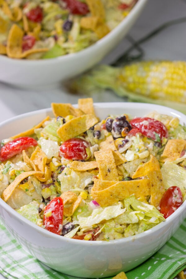 This Southwestern Chopped Salad features grilled corn, shredded cheese and lettuce tossed in a tangy southwestern dressing. Oh, and it gets topped with Fritos!