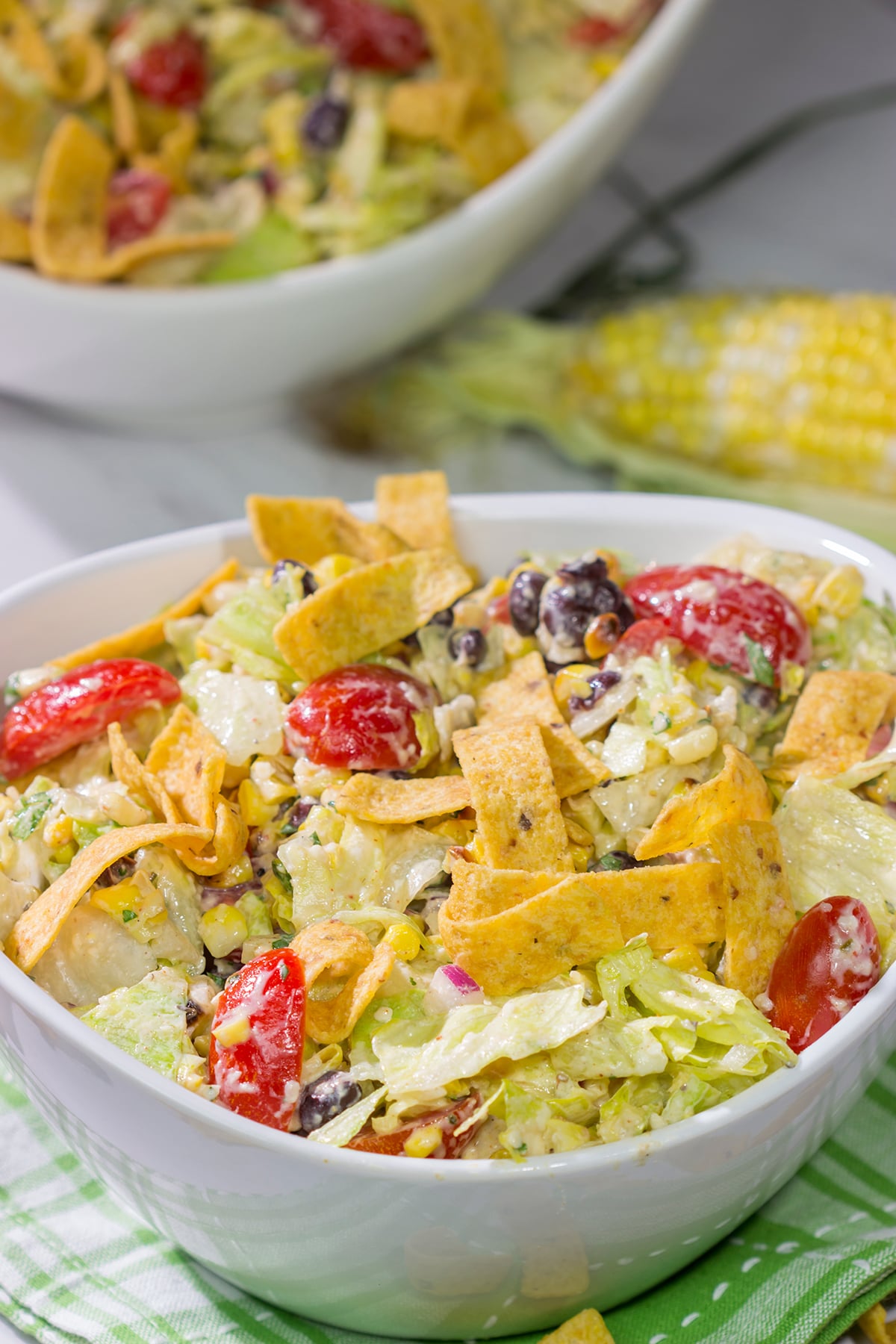 This Southwestern Chopped Salad features grilled corn, shredded cheese and lettuce tossed in a tangy southwestern dressing. Oh, and it gets topped with Fritos!