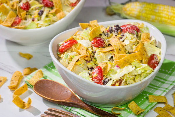 This Southwestern Chopped Salad features grilled corn, shredded cheese and lettuce tossed in a tangy southwestern dressing. Oh, and it gets topped with Fritos!
