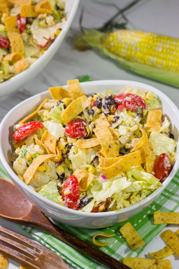 This Southwestern Chopped Salad features grilled corn, shredded cheese and lettuce tossed in a tangy southwestern dressing. Oh, and it gets topped with Fritos!