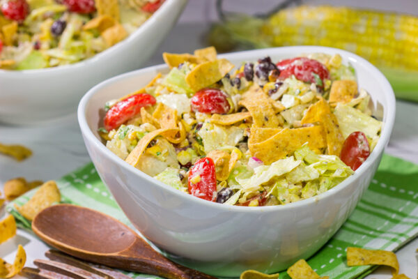 This Southwestern Chopped Salad features grilled corn, shredded cheese and lettuce tossed in a tangy southwestern dressing. Oh, and it gets topped with Fritos!