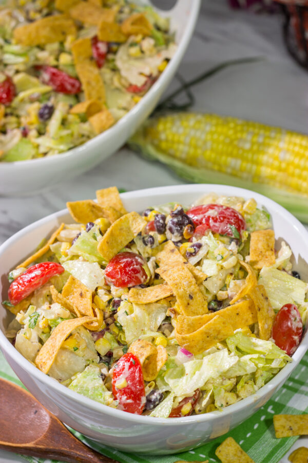 This Southwestern Chopped Salad features grilled corn, shredded cheese and lettuce tossed in a tangy southwestern dressing. Oh, and it gets topped with Fritos!