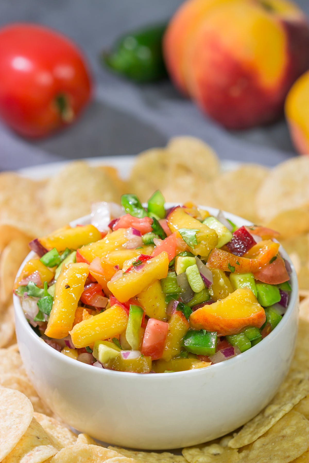 This Fresh Peach Salsa is an easy and delicious summer recipe! Serve it as a dip with chips or as a topping over grilled chicken.