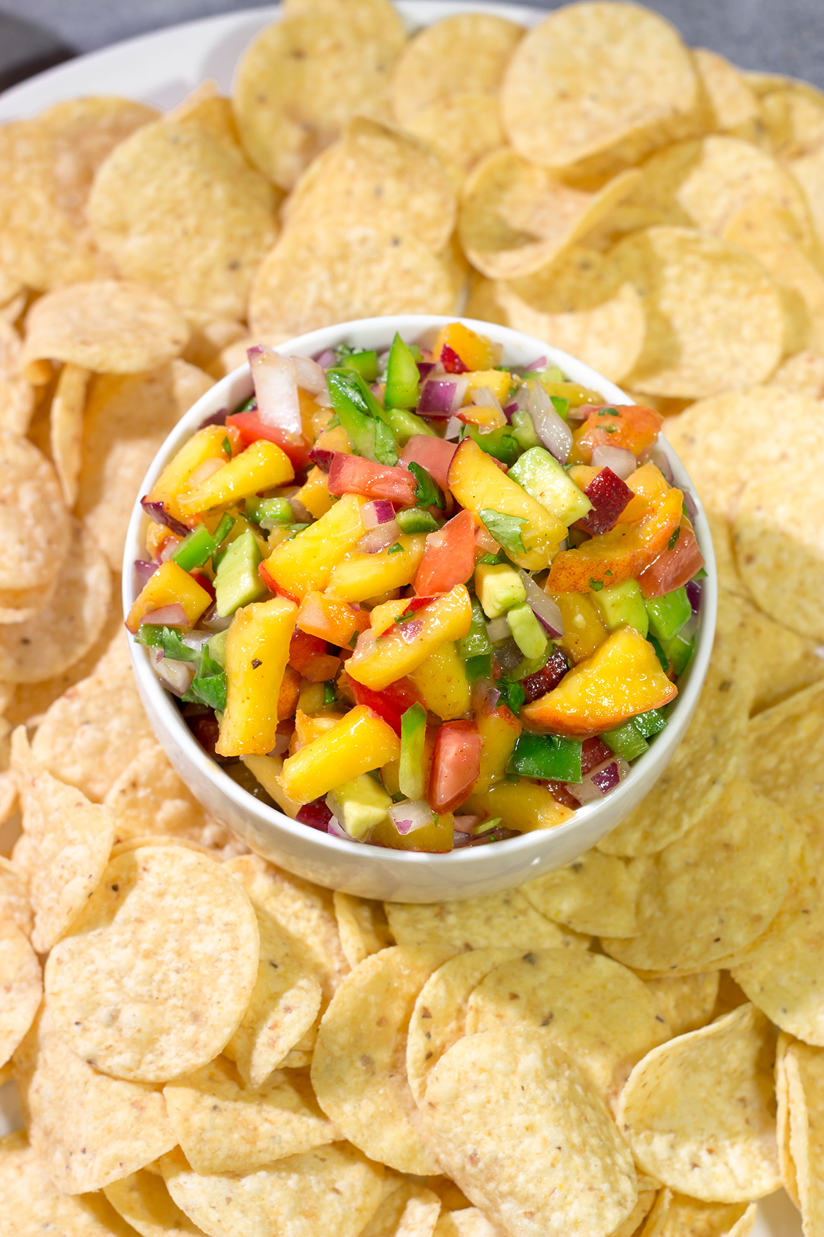 This Fresh Peach Salsa is an easy and delicious summer recipe! Serve it as a dip with chips or as a topping over grilled chicken.