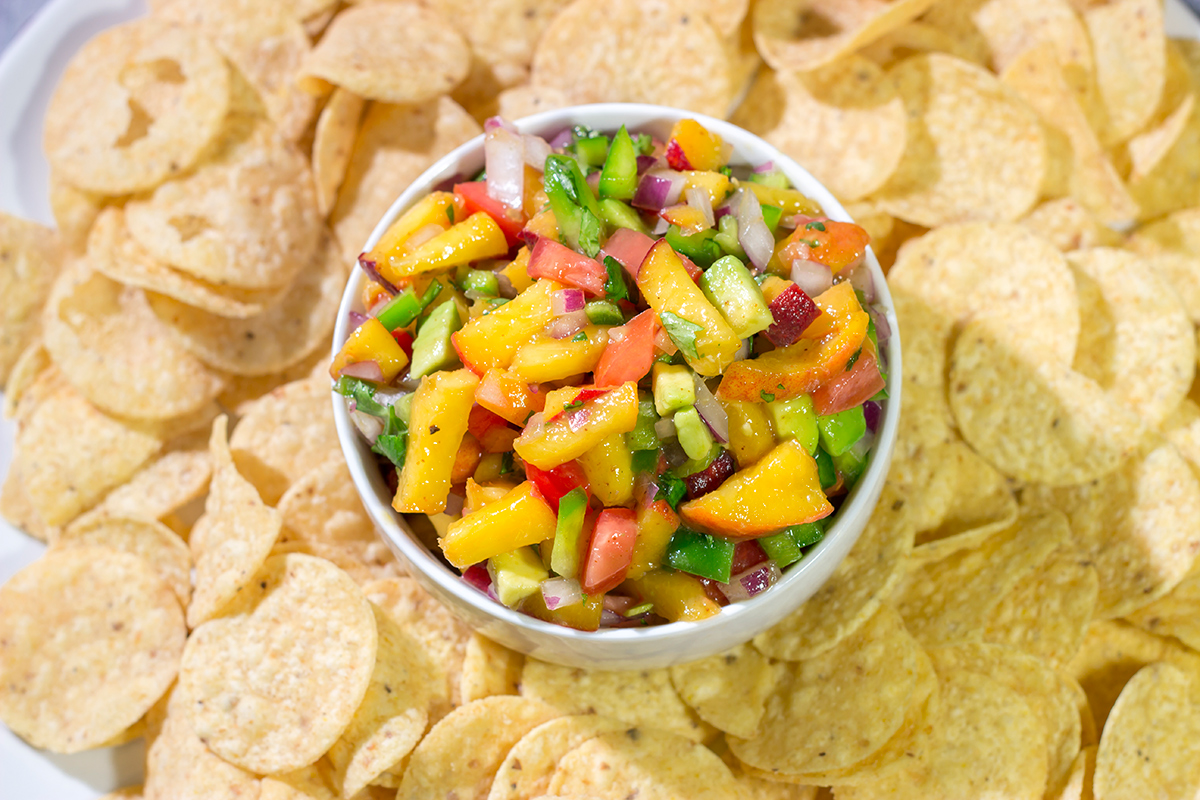 This Fresh Peach Salsa is an easy and delicious summer recipe! Serve it as a dip with chips or as a topping over grilled chicken.