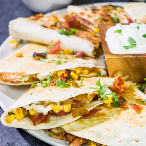 Looking for a fun way to mix up quesadilla night? Put these Goat Cheese and Green Chile Quesadillas on the menu! (Pssst - there's bacon involved!)