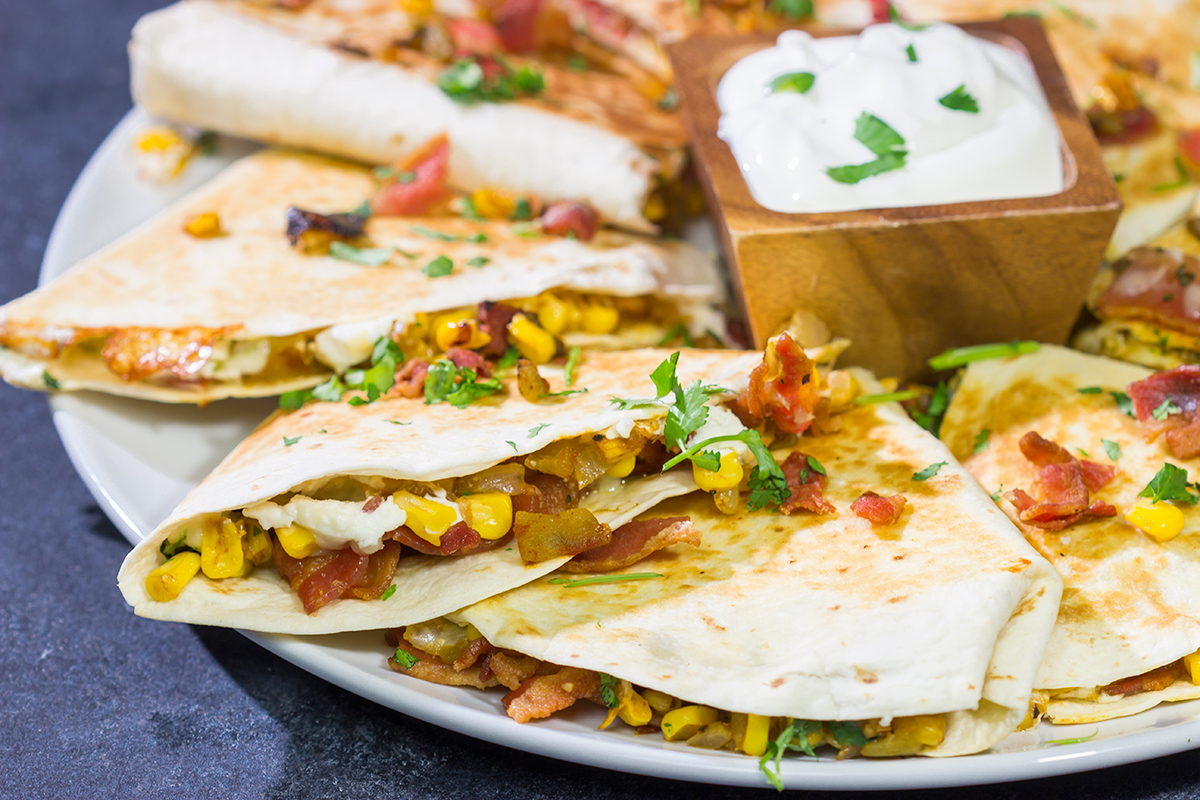 Looking for a fun way to mix up quesadilla night? Put these Goat Cheese and Green Chile Quesadillas on the menu! (Pssst - there's bacon involved!)