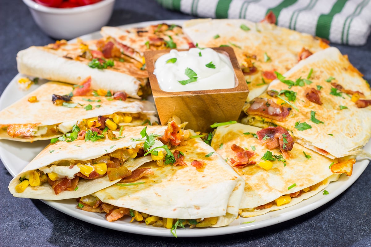 Looking for a fun way to mix up quesadilla night? Put these Goat Cheese and Green Chile Quesadillas on the menu! (Pssst - there's bacon involved!)