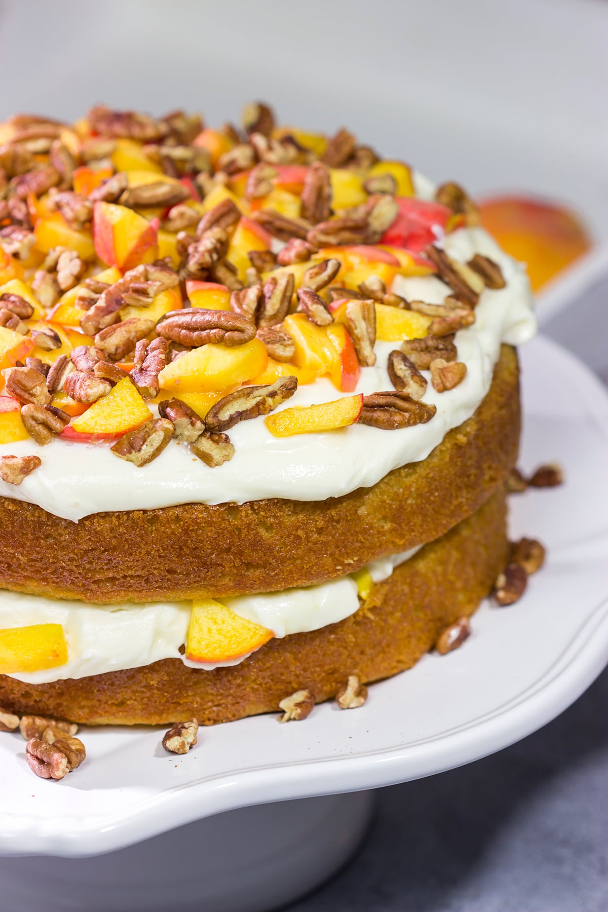 Featuring freshly grated ginger in both the cake as well as the frosting, this Peach Ginger Cake makes for a tasty dessert on a warm summer evening!