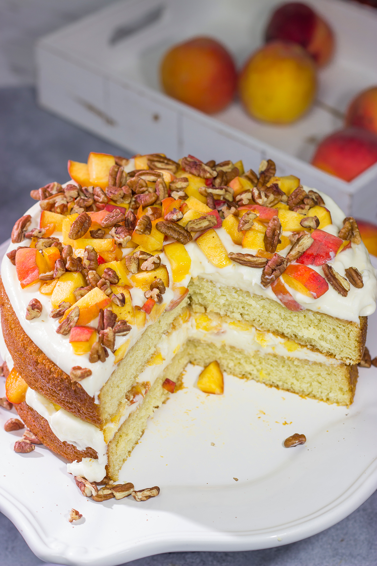 Featuring freshly grated ginger in both the cake as well as the frosting, this Peach Ginger Cake makes for a tasty dessert on a warm summer evening!