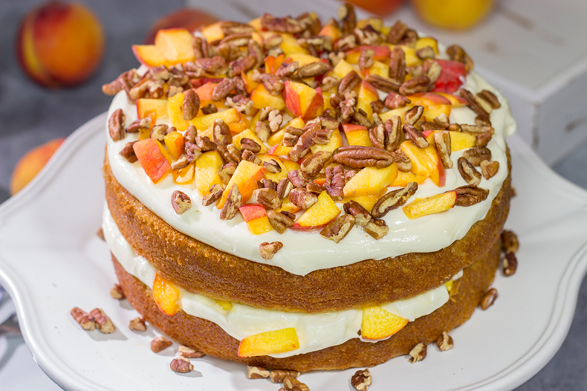 Featuring freshly grated ginger in both the cake as well as the frosting, this Peach Ginger Cake makes for a tasty dessert on a warm summer evening!