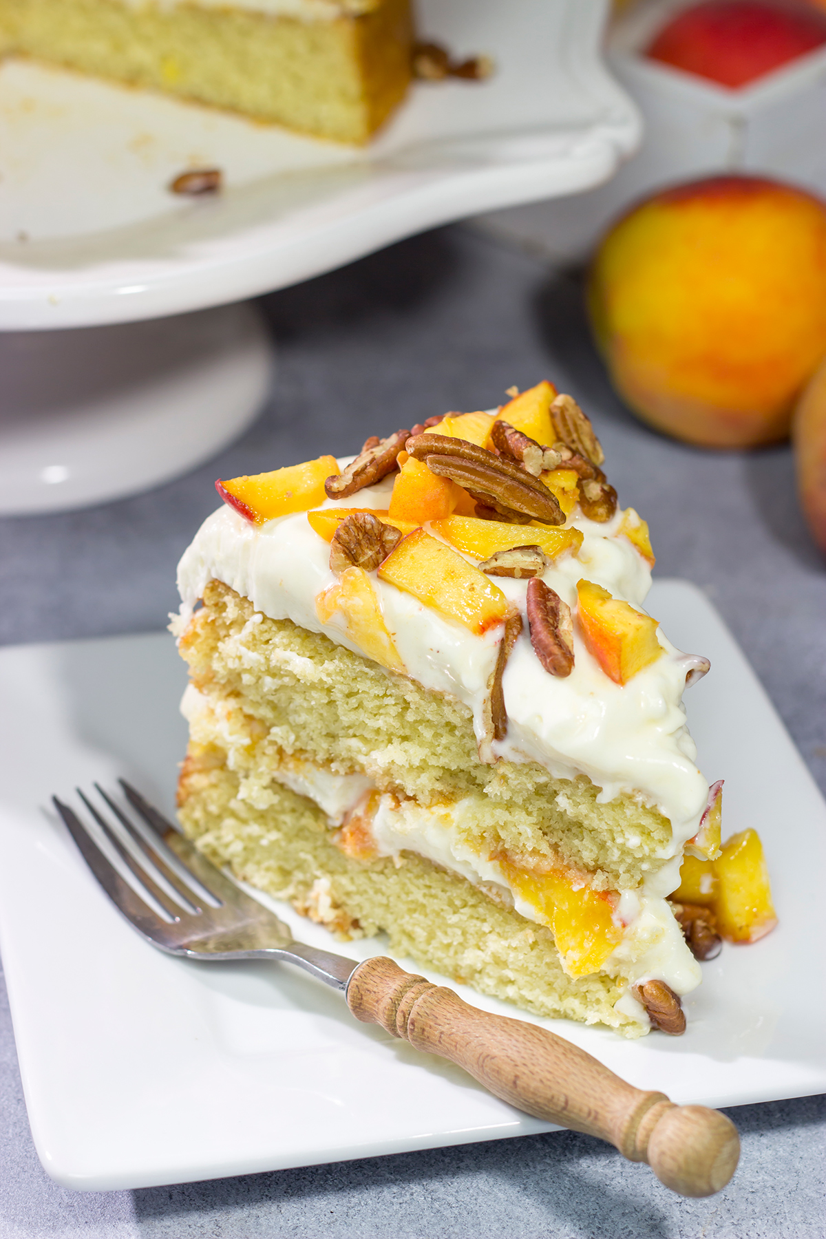 Featuring freshly grated ginger in both the cake as well as the frosting, this Peach Ginger Cake makes for a tasty dessert on a warm summer evening!