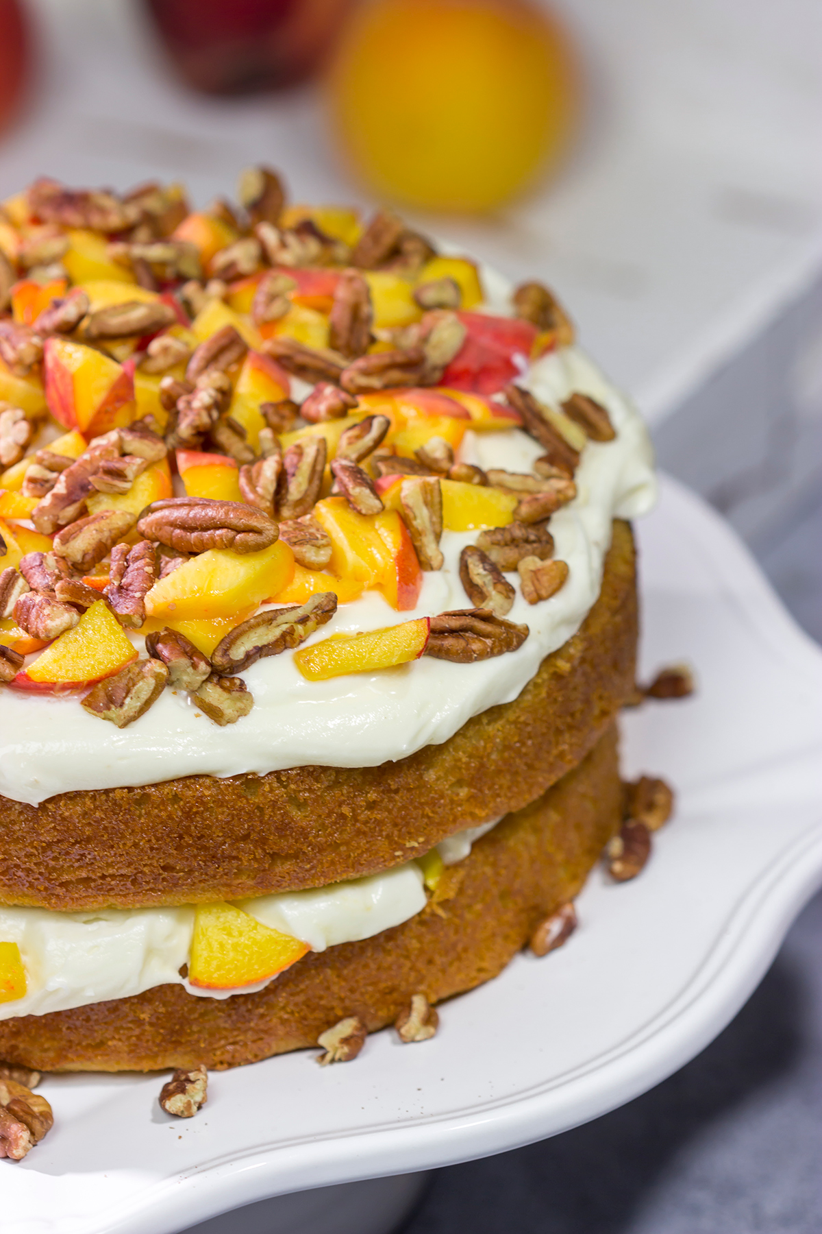 Featuring freshly grated ginger in both the cake as well as the frosting, this Peach Ginger Cake makes for a tasty dessert on a warm summer evening!