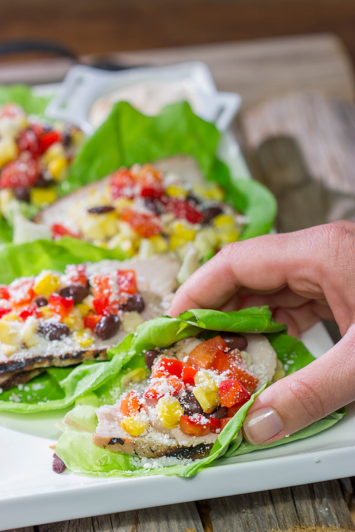 Filled with thinly sliced, marinated pork loin, grilled corn and chopped peppers, these Southwest Pork Lettuce Wraps make for a tasty gameday appetizer or meal!