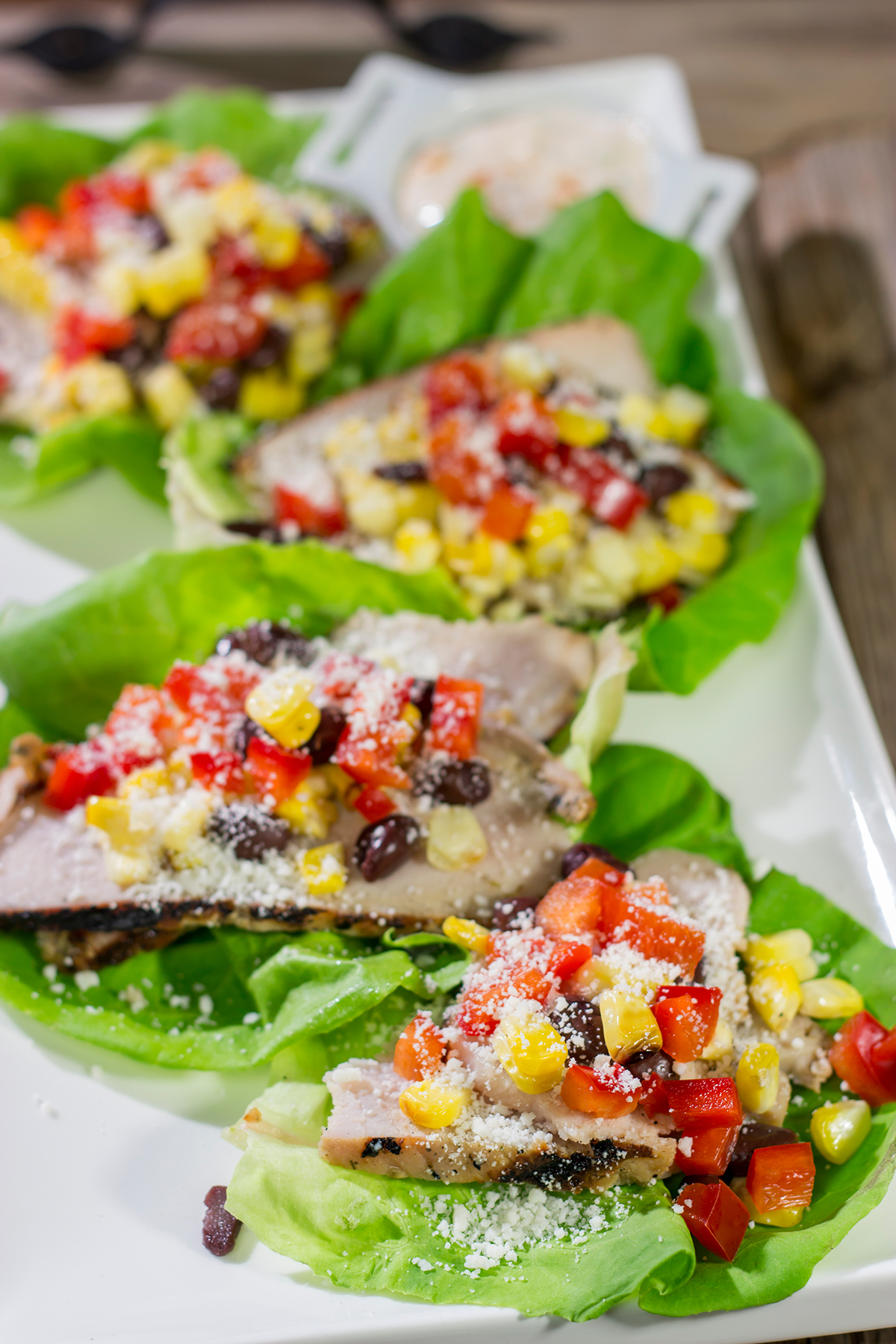 Filled with thinly sliced, marinated pork loin, grilled corn and chopped peppers, these Southwest Pork Lettuce Wraps make for a tasty gameday appetizer or meal!