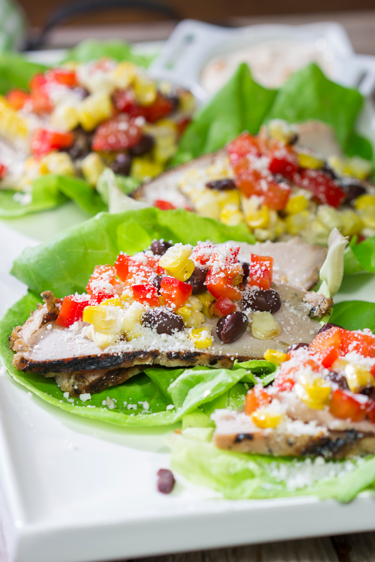 Filled with thinly sliced, marinated pork loin, grilled corn and chopped peppers, these Southwest Pork Lettuce Wraps make for a tasty gameday appetizer or meal!