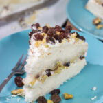 A Lady Baltimore Cake features white cake topped with 2 frostings, toasted walnuts and sherry-soaked raisins. It's truly a unique dessert!