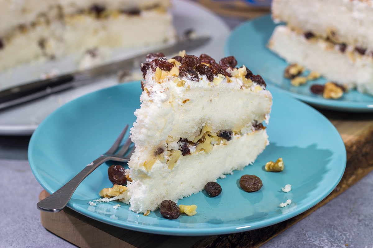 A Lady Baltimore Cake features white cake topped with 2 frostings, toasted walnuts and sherry-soaked raisins. It's truly a unique dessert!