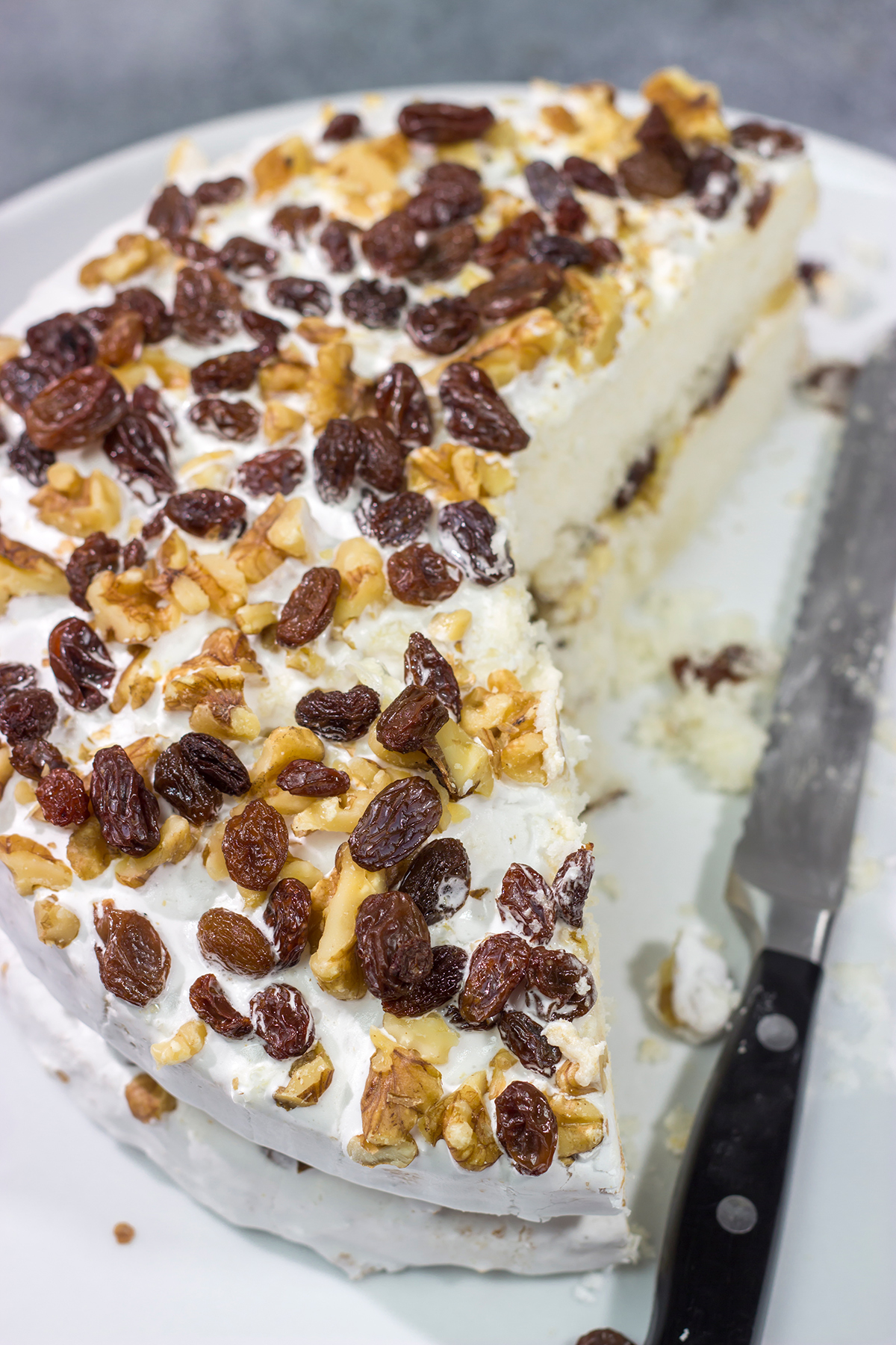 A Lady Baltimore Cake features white cake topped with 2 frostings, toasted walnuts and sherry-soaked raisins. It's truly a unique dessert!