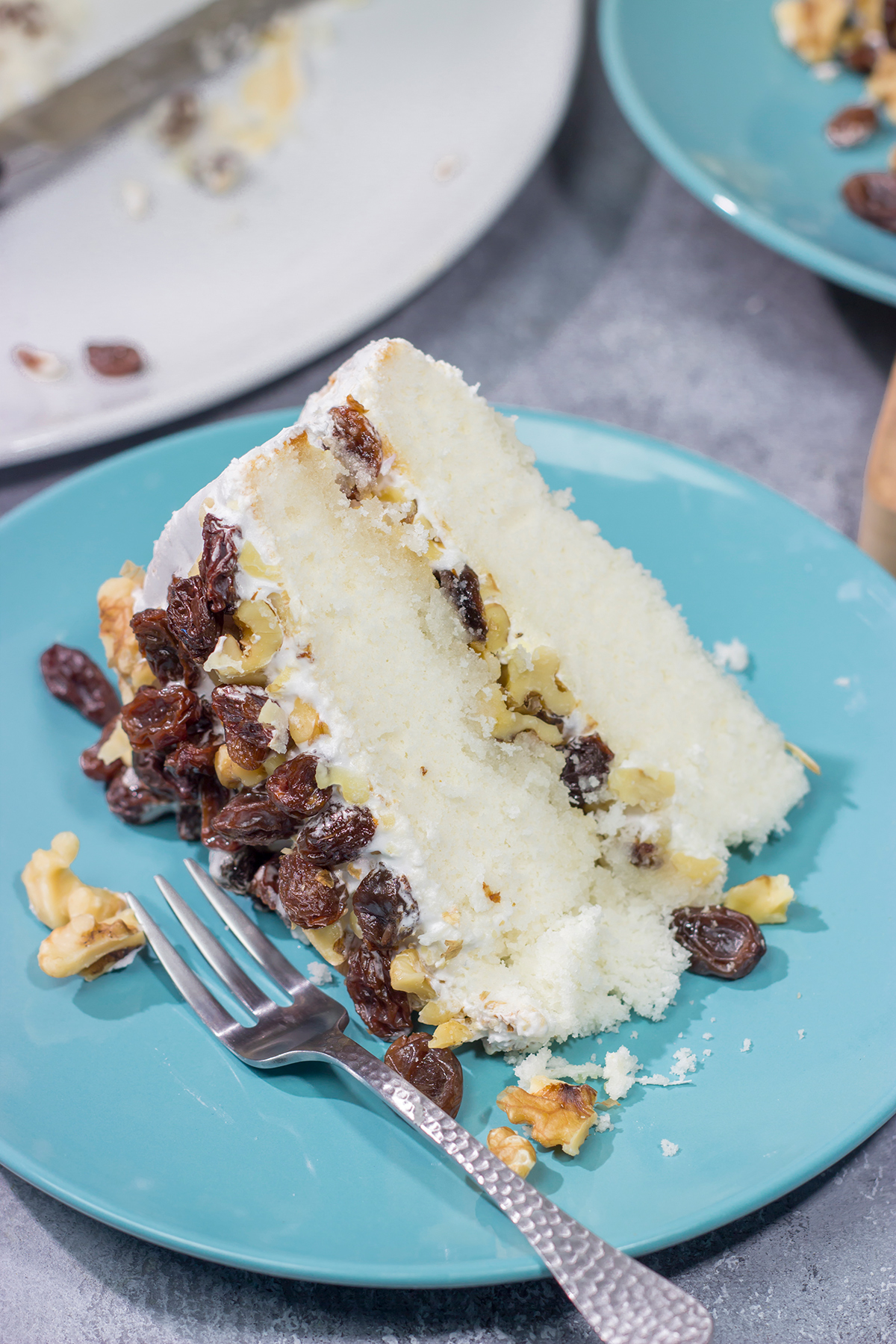 A Lady Baltimore Cake features white cake topped with 2 frostings, toasted walnuts and sherry-soaked raisins. It's truly a unique dessert!