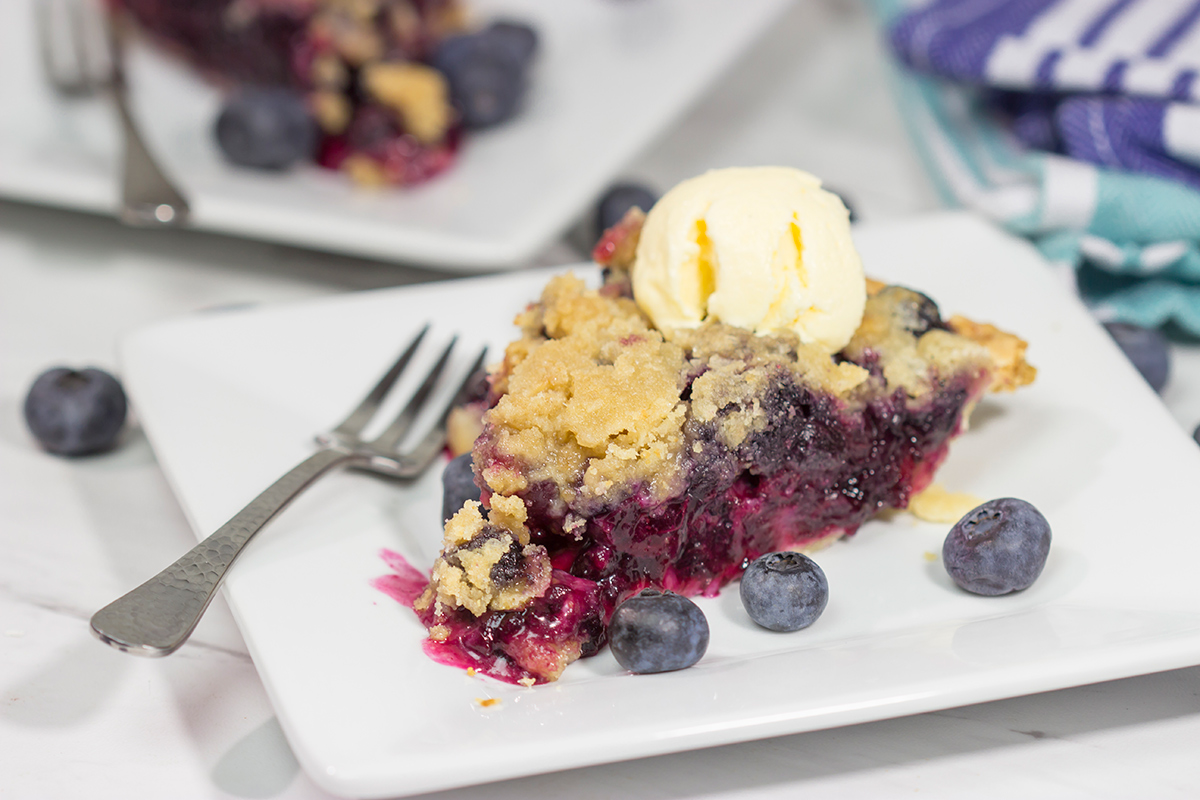 Packed with blueberries, this Blueberry Crumble Pie is a great dessert for a warm summer evening. Don't forget the scoop of ice cream on top!