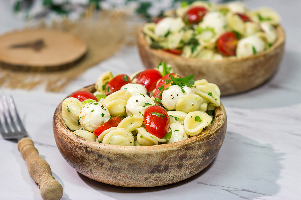 Traditional Caprese salad...in pasta salad form! This Caprese Pasta Salad is filled with fresh mozzarella, tomatoes and basil. It's a great summer side dish!