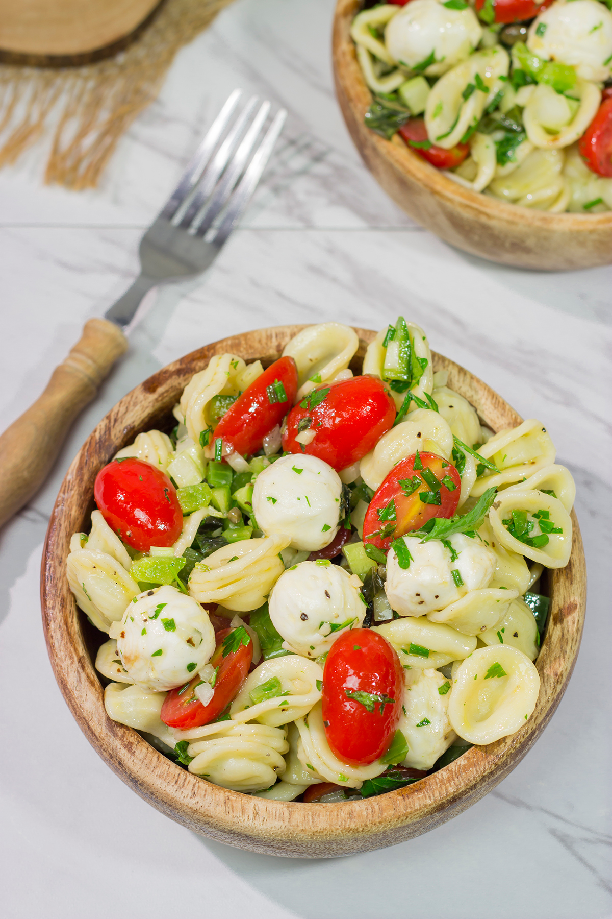 Traditional Caprese salad...in pasta salad form! This Caprese Pasta Salad is filled with fresh mozzarella, tomatoes and basil. It's a great summer side dish!