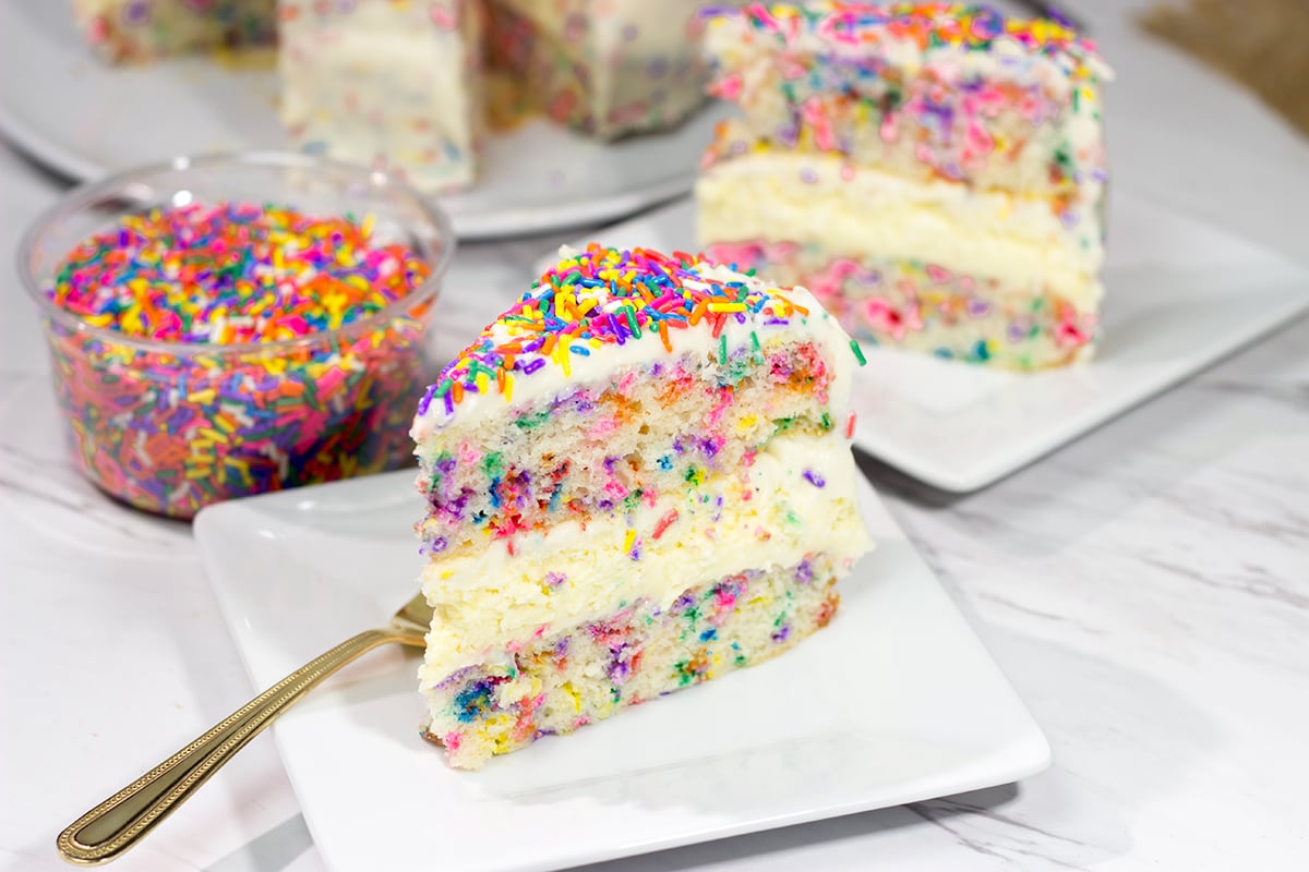 Everything's better with sprinkles! This Funfetti Cheesecake Cake features a layer of cheesecake in between two layers of white cake...and lots of sprinkles! It's a fun cake for any sort of celebration.