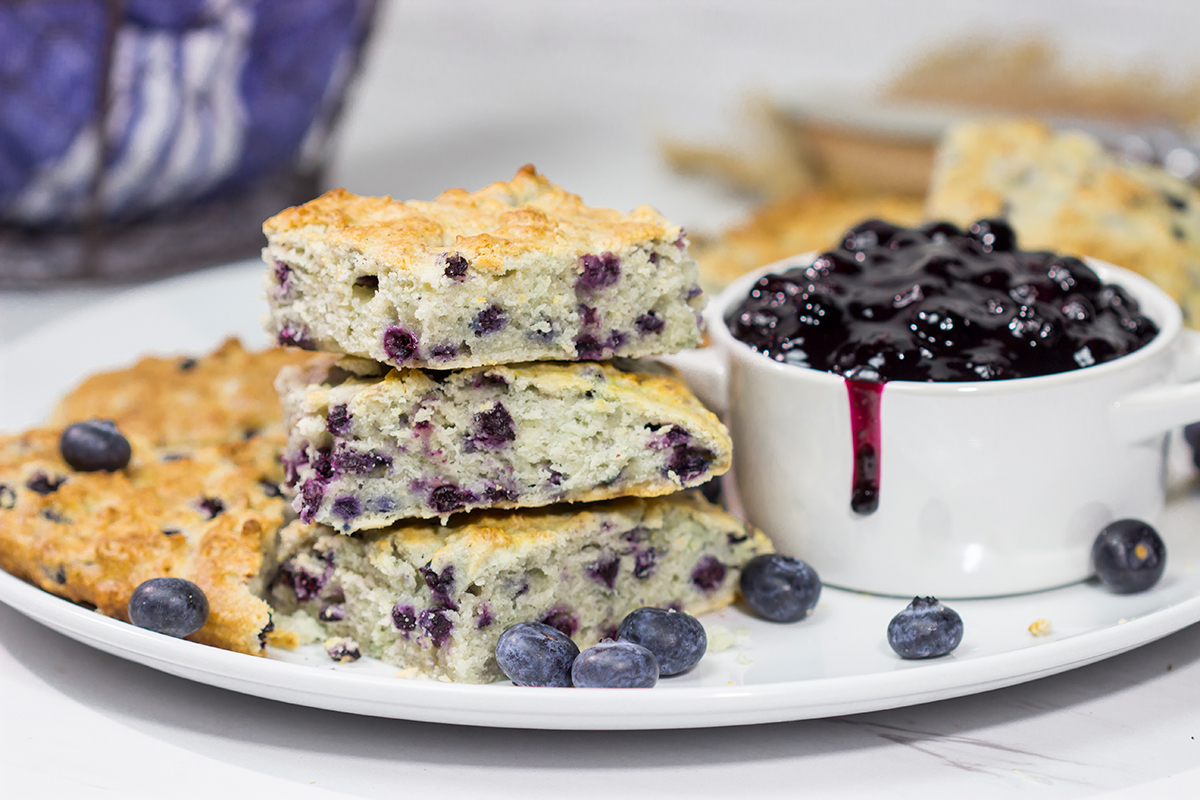 These Blueberry Cream Biscuits are served with blueberry sauce for maximum berry flavor. This easy recipe is great for summer weekend breakfasts!