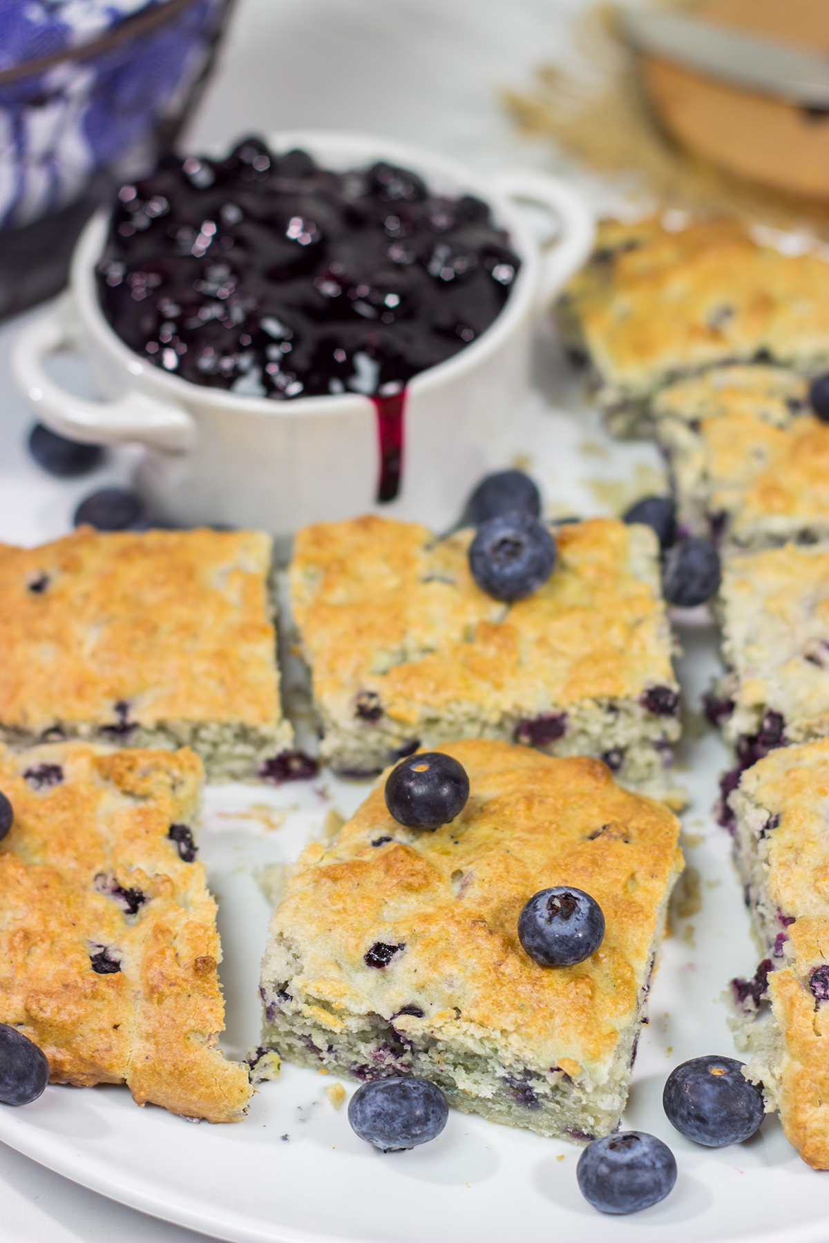 These Blueberry Cream Biscuits are served with blueberry sauce for maximum berry flavor. This easy recipe is great for summer weekend breakfasts!