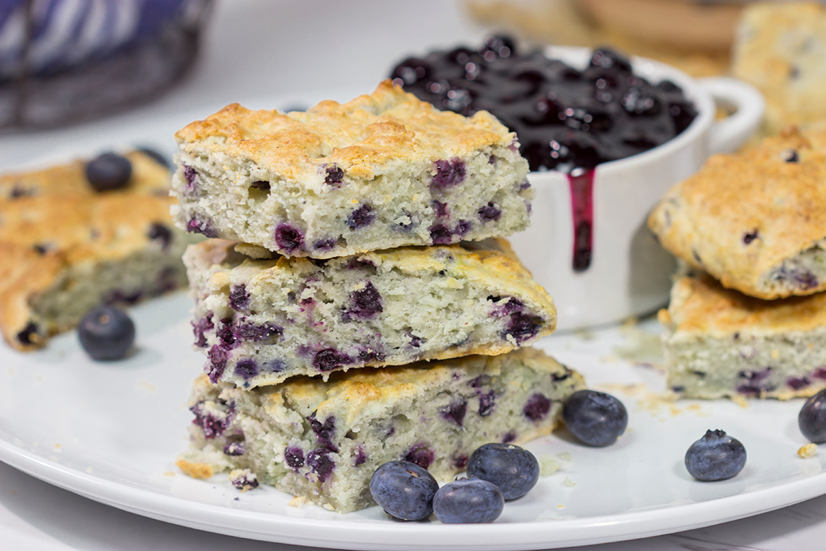 These Blueberry Cream Biscuits are served with blueberry sauce for maximum berry flavor. This easy recipe is great for summer weekend breakfasts!