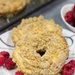 These baked Raspberry Crumb Donuts feature a cake-like base filled with fresh raspberries...and then topped with a thick layer of brown sugar crumble. They're delicious!
