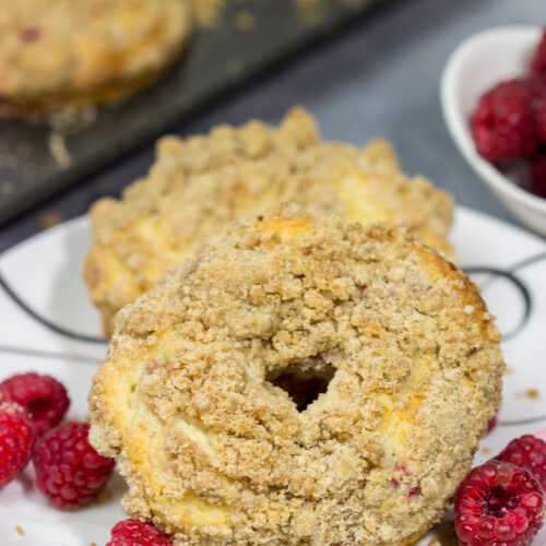 These baked Raspberry Crumb Donuts feature a cake-like base filled with fresh raspberries...and then topped with a thick layer of brown sugar crumble. They're delicious!