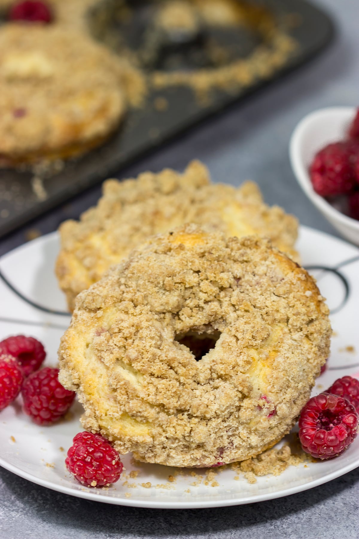 These baked Raspberry Crumb Donuts feature a cake-like base filled with fresh raspberries...and then topped with a thick layer of brown sugar crumble. They're delicious!